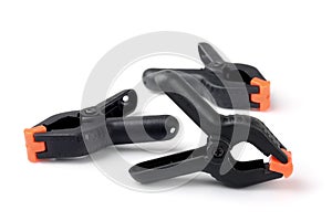 Three black plastic spring clamps
