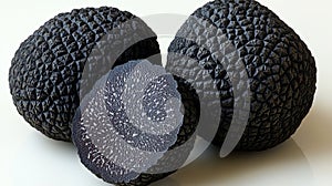 Three black truffles, one sliced