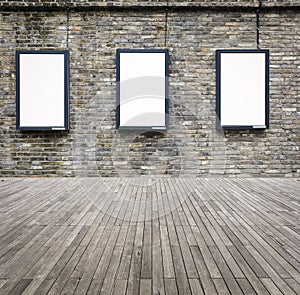 Three blank advertising light box on the wall