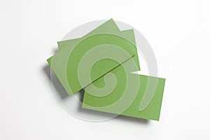 Three blank green textured business cards isolated on white, composition concept for presentation, studio shot