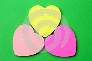 Three blank heart shaped stickers with space for text. Creative symbolic background