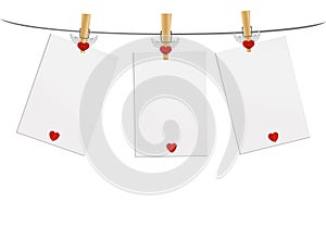 Three blank paper with red heart hanging on the wooden cloth peg