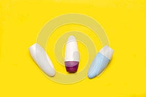 Three blank plastic bottles on a yellow background