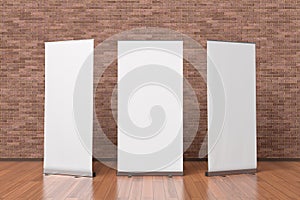 Three blank roll up banner stands