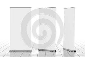 Three blank roll up banner stands