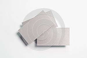 Three blank silver textured business cards isolated on white, composition concept for presentation, studio shot