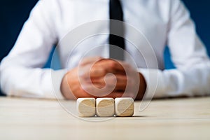 Three blank wooden dices in a row