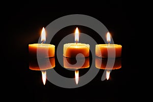 Three blazing wax candles photo