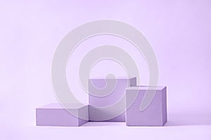 Three blocks of podium square cubes of different heights for displaying and advertising the product. Podium mockup for
