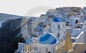 The three blue domes of the churches of Agios Spiridonas and Anasteseos in Oia, on Santorini, Greece