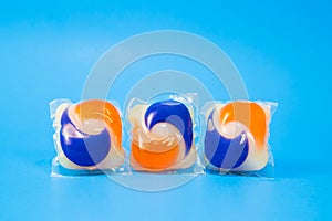 Laundry detergent pods capsules on a blue background photo