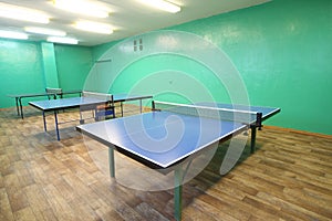 Three blue ping pong tables in the