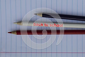 are three blue, white and red pencils with the words `Back to School