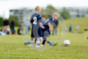 Three blurred soccer kids