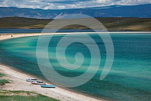 Three boats on the beach of Baikal lake