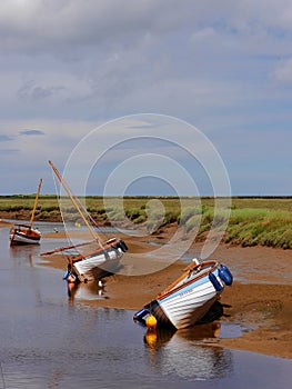 Three boats in gorgeous Blakeney, North Norfolk coast, East Anglia, UK