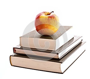 Three books and apple isolated