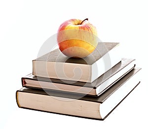 Three books and apple isolated
