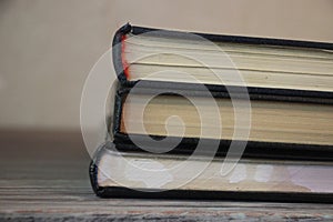 Three books on old table egde. Knowledge concept. focus selected photo