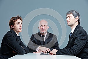 Three bored businessmen in a meeting