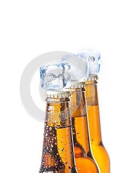 Three bottle of fresh beer with ice and drops