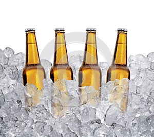 Three bottles of beer on ice cubes Isolated on white background