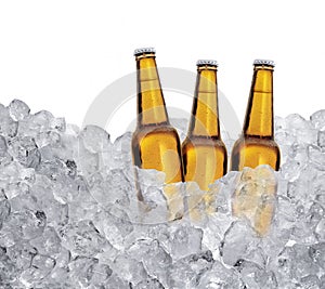 Three bottles of beer on ice cubes Isolated on white background