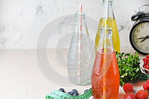 Three bottles of a drink with basil seeds. Light photography with copy space