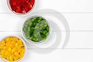 Three bowls with colorful paprikas