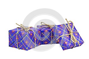 Three boxes of gifts packed in festive blue packaging, white background