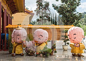 Three boy monk dolls at Hsi Lai Buddhist Temple, California.