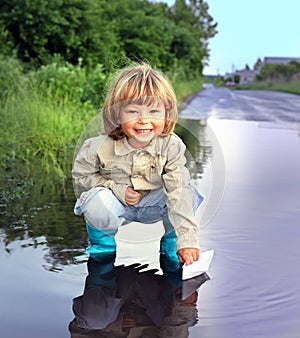 Three boy play in puddle