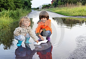 Three boy play in puddle
