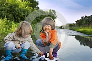 Three boy play in puddle