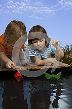 Three boy play in puddle