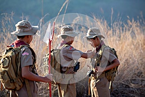 The three Boy Scouts talk to each other before making