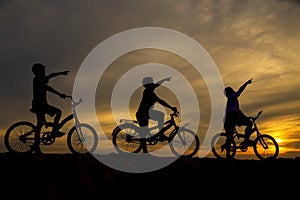 Three boys cycling along the front