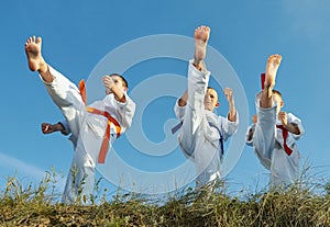 Three boys in karategi beats punch mae geri