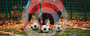 Three boys on soccer training in autumn time. Fall soccer outdoor practice session