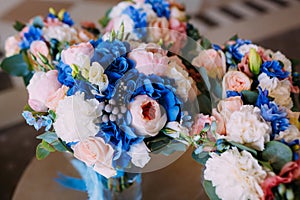 Three Bridal bouquets with creamy roses and peonies and blue hydrangeas. Wedding morning. Close-up