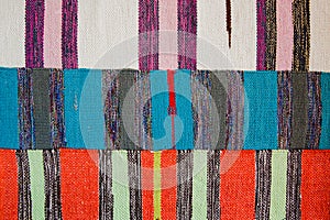 Three bright textile striped rugs with lilac, blue, red and white stripes. Textile texture