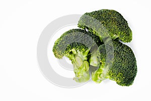 Three broccoli branches on white background.