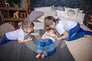 Three brothers are lying on the bed. brotherly love big family,