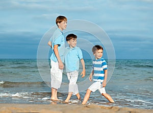 Three brothers are play on beach