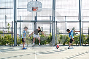 Three brothers playing football, one of them has a leg prosthesis and is kicking a penalty