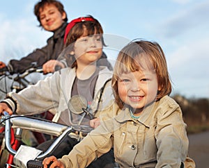 Three brothers ride bikes