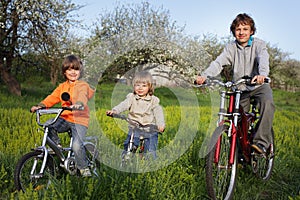 Three brothers ride bikes