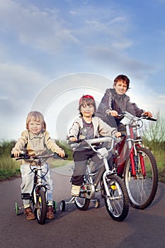 Three brothers ride bikes