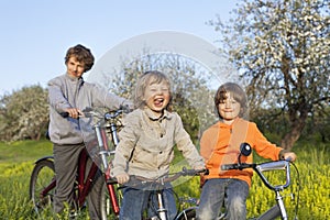 Three brothers ride bikes