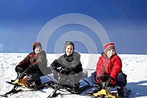 Three brothers tobogganing